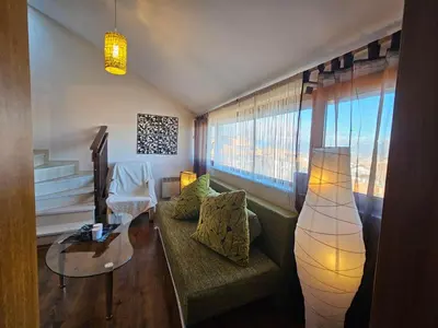 a living room with a couch and a table at Ioannis Apartment Bansko in Bansko