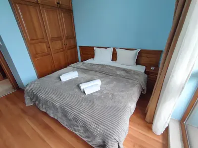 a bedroom with a bed with two white towels on it at Belvedere Holiday Club SPA&POOL Private Apartments in Bansko