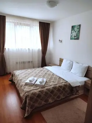 a bedroom with a large bed with two towels on it at Belvedere Holiday Club SPA&POOL Private Apartments in Bansko