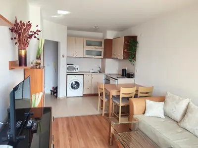 a living room and kitchen with a couch and a table at Belvedere Holiday Club SPA&POOL Private Apartments in Bansko