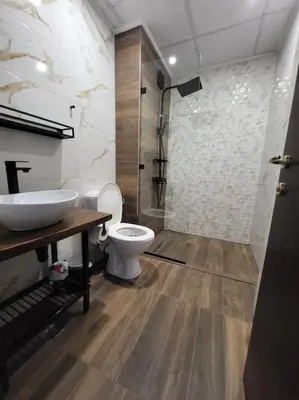 a bathroom with a toilet and a sink and a shower at KS Rooftop 180° in Bansko