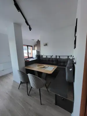 a dining room with a table and a couch at KS Rooftop 180° in Bansko