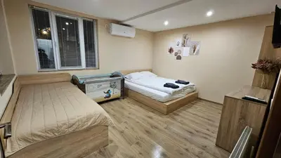 a small room with two beds and a window at Вила Доброво in Dobrovo