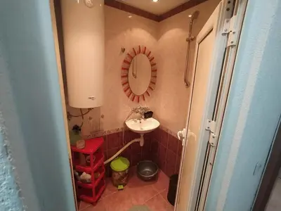 a small bathroom with a sink and a mirror at Apartment sunny morning in Sandanski