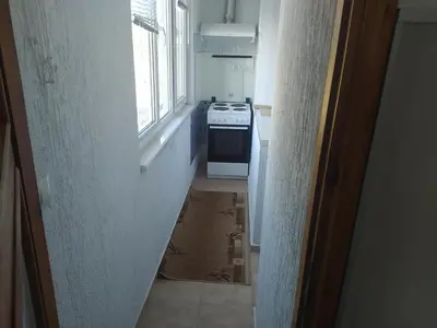 a small kitchen with a stove and a window at Apartment sunny morning in Sandanski