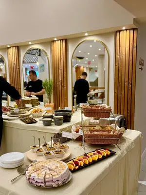 a buffet line with many different types of food at Pirin Sense Apartment Complex in Bansko