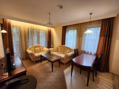 a living room with a couch and a table at Luxury Downtown Appartment - 150m ski lift Gondola in Bansko