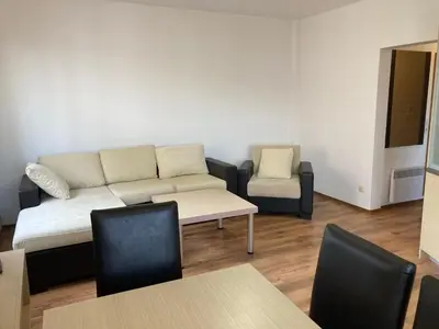 a living room with a couch and a table and chairs at Apartment 26А Detelina Residence in Bansko