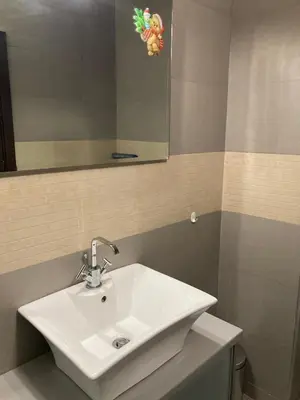 a bathroom with a white sink and a mirror at Apartment 26А Detelina Residence in Bansko