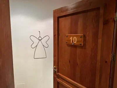 a wooden door with a butterfly on the wall at Family Luxury Private Apartments in 4 star SPA Resort St Ivan Rilski, Bansko in Bansko