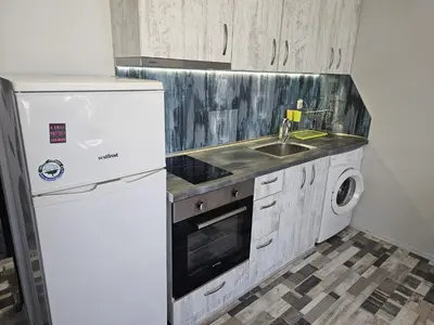 a kitchen with a white refrigerator and a sink at Studio Apartament 47А- Trakia 54 А in Plovdiv