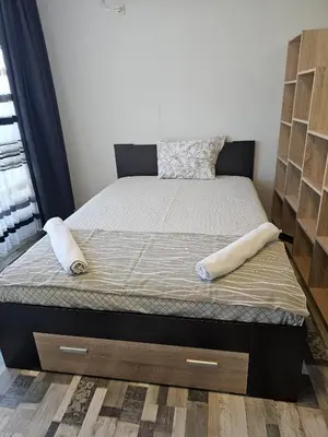 a bed with two pillows on it in a bedroom at Studio Apartament 47А- Trakia 54 А in Plovdiv