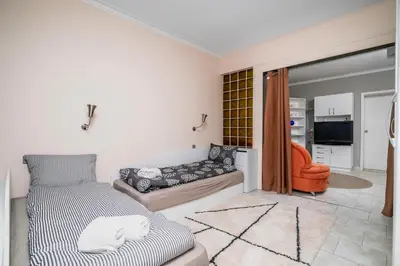 a living room with a bed and a couch at Cozy Apartment near Vitosha Street by Flat Mаnager in Sofia