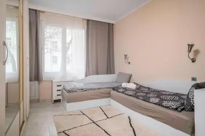 a small bedroom with two beds and a window at Cozy Apartment near Vitosha Street by Flat Mаnager in Sofia
