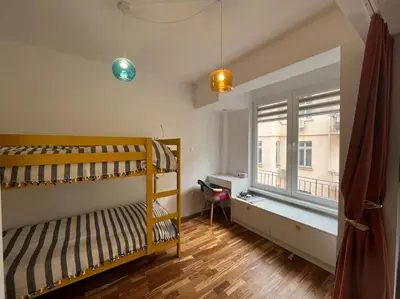 a bedroom with a bunk bed and a window at Family friendly downtown apart in Sofia