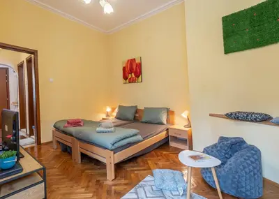 a bedroom with a bed and a tv in it at Vintage Home by NDK and Vitosha Blvd with Free Secured Parking in Sofia