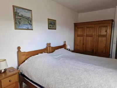 a bedroom with a wooden bed and a wooden cabinet at Saint John Hill Apartment in Bansko
