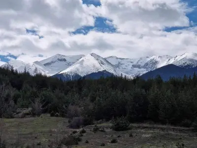 a mountain range with snow capped mountains in the distance at Saint John Hill Apartment in Bansko