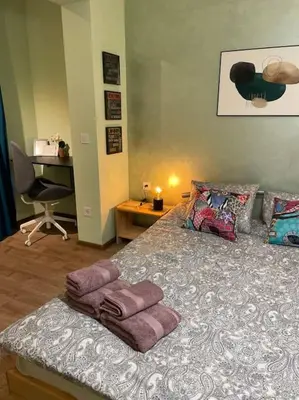 a bedroom with a bed with purple towels on it at Sweet Studio Office & Amazing Coffee in Sofia