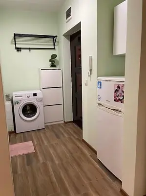 a laundry room with a washing machine and a washer at Sweet Studio Office & Amazing Coffee in Sofia