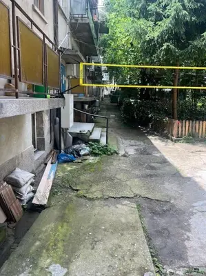 an alley with a building and a yellow caution tape at 3 BR Apt, Spacious, Near South Park in Sofia
