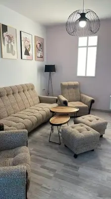 a living room with a couch and a table and chairs at 3 BR Apt, Spacious, Near South Park in Sofia