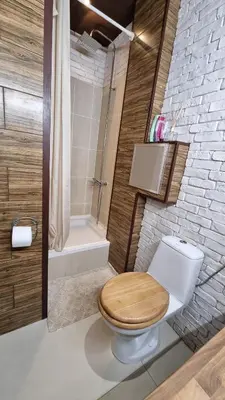 a bathroom with a wooden toilet and a bath tub at Central Apartment in Sofia