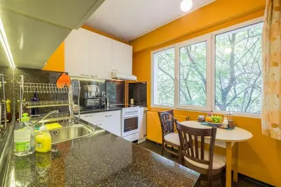 a kitchen with a sink and a table with chairs at Beautiful Flat in Central Location by Flat Mаnager in Sofia
