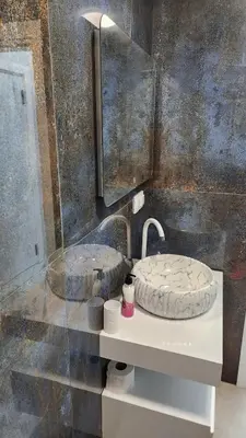 a bathroom with a sink and a mirror at Димоти Апартхотел in Sofia