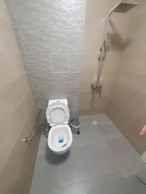 a bathroom with a white toilet in a stall at Димоти Апартхотел in Sofia