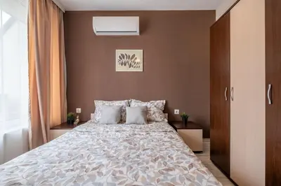 a bedroom with a large bed with pillows at Cozy Homes 2 in Sofia