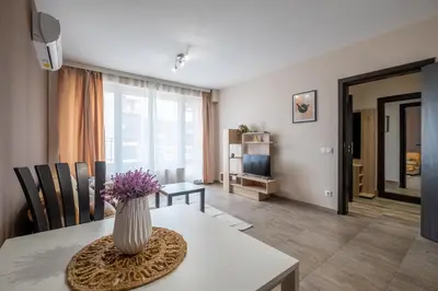 a living room with a vase of flowers on a table at Cozy Homes 2 in Sofia