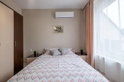 a bedroom with a bed and a window at Cozy Homes 3 in Sofia