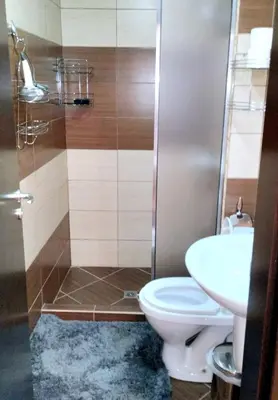 a bathroom with a toilet and a sink at Spacious luxury studio with mountain view - SPA available in Bansko