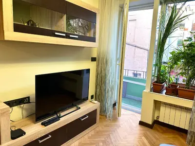 a living room with a large flat screen tv at Luxury Oasis in absolute Center of Sofia in Sofia