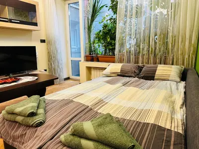 a bedroom with a large bed and a television at Luxury Oasis in absolute Center of Sofia in Sofia