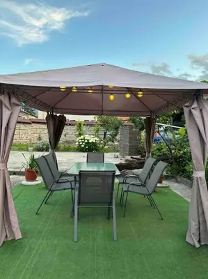 a patio with a table and chairs under a canopy at Villa Fest in Bansko