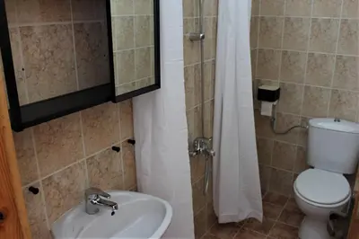 a bathroom with a toilet and a sink and a shower at Villa Fest in Bansko
