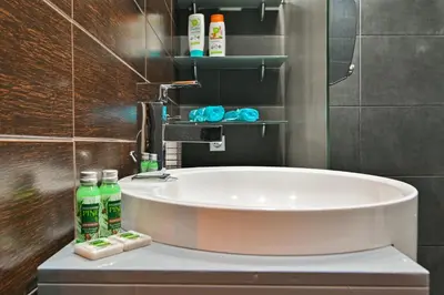a bathroom with a sink and a bath tub at Neofit Rilski Apartment (near Vitoshka street) in Sofia