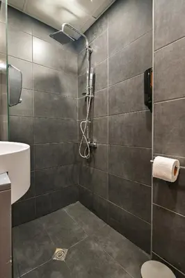 a bathroom with a shower with a toilet and a sink at Neofit Rilski Apartment (near Vitoshka street) in Sofia