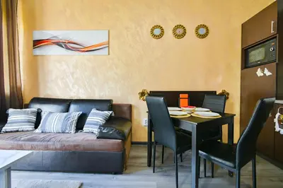 a living room with a couch and a table at Neofit Rilski Apartment (near Vitoshka street) in Sofia