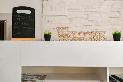 a white counter top with a white brick wall at Neofit Rilski Apartment (near Vitoshka street) in Sofia