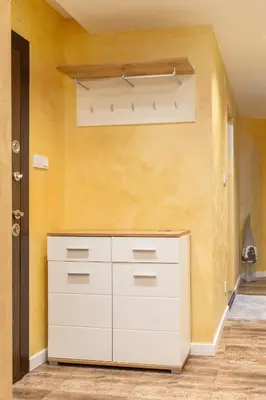 a white cabinet in a room with a yellow wall at Bansko Getaway- Ski & Summer Activities , sleep 6 in Bansko