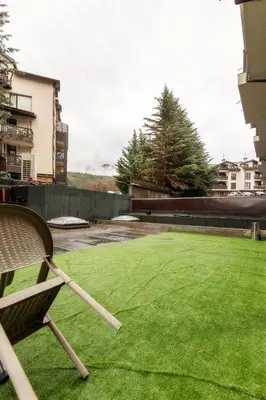 a chair sitting on a lawn in a yard at Bansko Getaway- Ski & Summer Activities , sleep 6 in Bansko
