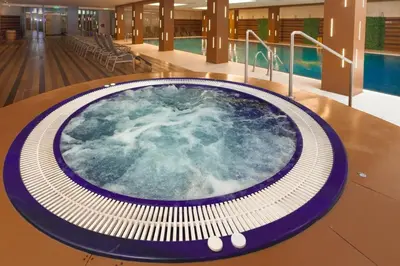 a hot tub in the middle of a building with a pool at Cozy Mountain Apartment in Borovets