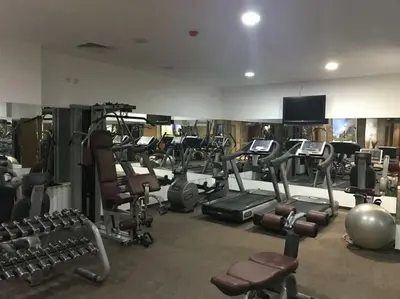 a gym with a bunch of exercise equipment in it at Cozy Mountain Apartment in Borovets