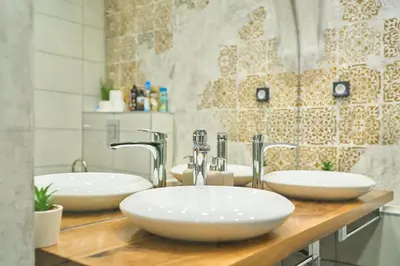 a bathroom with two white sinks on a wooden counter at Luxury 2 Bedroom Apartment - Private Garden in Sofia