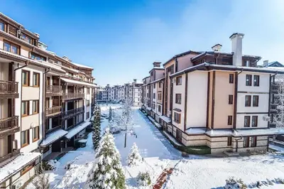 a city street covered in snow with buildings at Ski Lift Delight Bansko Apartment in Bansko