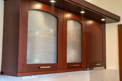 a wooden cabinet with three windows in a kitchen at Ski Lift Delight Bansko Apartment in Bansko