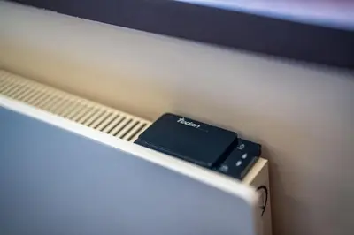 a cell phone sitting on a shelf in a bed at Ski Lift Delight Bansko Apartment in Bansko